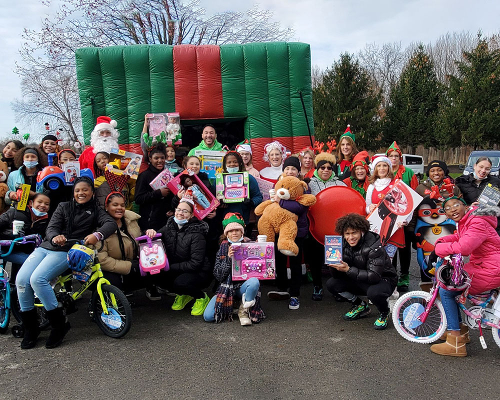 Batch a Toys Volunteers in front of bounce house